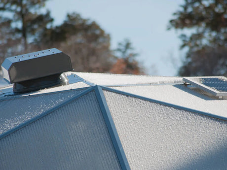 A solar attic fan on the roof of a Growing Dome
