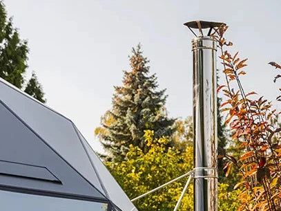A stainless steel chimney standing beside a GeoHome